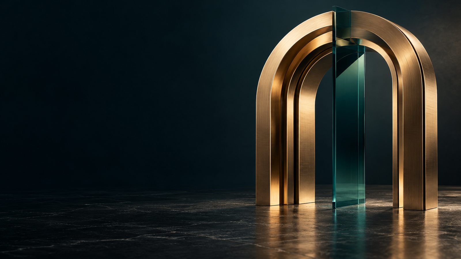 A brass arch with a glass panel on dark stone